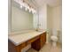 Bright bathroom featuring a large mirror, ample countertop space, and a classic toilet at 3533 Mulberry Way, Duluth, GA 30096