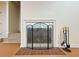 Close-up of fireplace with decorative screen and tools at 3533 Mulberry Way, Duluth, GA 30096