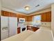 Features an oven, microwave, and cabinets with a window providing light and a sink at 3533 Mulberry Way, Duluth, GA 30096