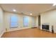 Spacious living area with wood-look floors, fireplace, and multiple windows for natural light at 3533 Mulberry Way, Duluth, GA 30096