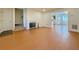 Bright living room featuring wood-look flooring, a fireplace, and access to other rooms at 3533 Mulberry Way, Duluth, GA 30096