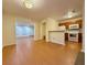 Open living space with wood-look floors, leading to the kitchen with a breakfast bar at 3533 Mulberry Way, Duluth, GA 30096