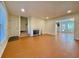 Bright living room featuring wood-look flooring, a fireplace, and access to other rooms at 3533 Mulberry Way, Duluth, GA 30096