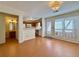 Open floorplan includes kitchen view with eat-in bar, wood floors and light-filled windows at 3533 Mulberry Way, Duluth, GA 30096