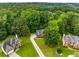 Aerial view showcasing a brick home with well-manicured lawns and mature trees at 4137 Donna Ct, Ellenwood, GA 30294
