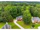 Aerial view of a brick home with a long driveway surrounded by lush greenery at 4137 Donna Ct, Ellenwood, GA 30294