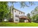 Back of the house with a deck, fenced yard, and lush greenery at 4137 Donna Ct, Ellenwood, GA 30294