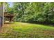 Exterior view of a two-story home featuring a deck and fenced-in backyard at 4137 Donna Ct, Ellenwood, GA 30294