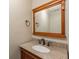 Bathroom featuring granite countertops, wood cabinetry and a decorative framed mirror at 4137 Donna Ct, Ellenwood, GA 30294