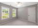 Neutral bedroom featuring a ceiling fan, carpet, and two large windows at 4137 Donna Ct, Ellenwood, GA 30294
