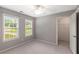 Bedroom featuring a ceiling fan, carpet, large windows, and walk-in closet at 4137 Donna Ct, Ellenwood, GA 30294