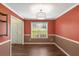 Dining room features hardwood floors, modern lighting and view to the front entryway at 4137 Donna Ct, Ellenwood, GA 30294
