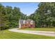 Inviting two-story home with a long driveway and a spacious front yard with mature trees at 4137 Donna Ct, Ellenwood, GA 30294