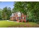 Attractive brick home featuring a well-maintained lawn, classic architecture and inviting entryway at 4137 Donna Ct, Ellenwood, GA 30294
