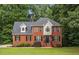 Beautiful red brick two-story home with black shutters and a well-manicured lawn at 4137 Donna Ct, Ellenwood, GA 30294