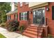 Welcoming front entry with brick steps and black railing leading to a stylish front door at 4137 Donna Ct, Ellenwood, GA 30294