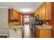 Well-lit kitchen featuring wood cabinets, granite countertops, and stainless steel appliances at 4137 Donna Ct, Ellenwood, GA 30294