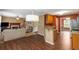 Open kitchen with breakfast bar flowing into a living room and featuring wood cabinets and granite countertops at 4137 Donna Ct, Ellenwood, GA 30294