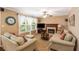 Cozy living room with a fireplace, plush seating, and a ceiling fan at 4137 Donna Ct, Ellenwood, GA 30294
