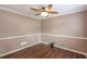 Cozy room featuring hardwood floors, crown molding and a modern ceiling fan with light fixture at 4137 Donna Ct, Ellenwood, GA 30294