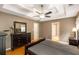 Comfortable main bedroom with a tray ceiling, a ceiling fan, and good closet space at 4137 Donna Ct, Ellenwood, GA 30294