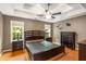 Spacious main bedroom with a tray ceiling, a ceiling fan, and lots of natural light at 4137 Donna Ct, Ellenwood, GA 30294