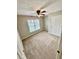 Bedroom features neutral carpeting and a ceiling fan at 1435 Great Oaks Dr, Lawrenceville, GA 30045