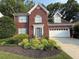 Charming two-story brick home with a well-manicured lawn and a two-car garage at 1435 Great Oaks Dr, Lawrenceville, GA 30045