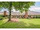 Picturesque backyard with mature trees, lush lawn, and brick patio, perfect for outdoor enjoyment at 535 Brickleberry Ln, Roswell, GA 30075