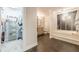 Bathroom with a soaking tub with tile accents next to a walk-in closet at 535 Brickleberry Ln, Roswell, GA 30075