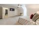 Carpeted bedroom featuring a ceiling fan and TV, with access to the en-suite bathroom at 535 Brickleberry Ln, Roswell, GA 30075