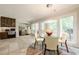 Bright breakfast nook with a glass table, tiled floors and an outdoor patio view at 535 Brickleberry Ln, Roswell, GA 30075
