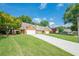 Long driveway to attractive brick homes with well-manicured lawns on a sunny day at 535 Brickleberry Ln, Roswell, GA 30075