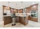 Spacious kitchen features stainless appliances, granite countertops, tile backsplash, and eat-in breakfast bar at 535 Brickleberry Ln, Roswell, GA 30075