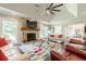 Bright living room with a stone fireplace, large windows, and comfortable sofas at 535 Brickleberry Ln, Roswell, GA 30075