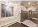 Updated main bathroom featuring a walk-in shower, and a large soaking tub for a luxurious experience at 535 Brickleberry Ln, Roswell, GA 30075