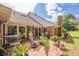 A brick patio area features stylish outdoor seating and a grill, surrounded by well-manicured greenery at 535 Brickleberry Ln, Roswell, GA 30075