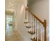 Staircase with carpet steps, wood trim and a tiled floor at 535 Brickleberry Ln, Roswell, GA 30075
