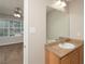 Bathroom vanity featuring a white countertop and wooden cabinets and an oversized mirror at 6010 Capitol Knl, Fairburn, GA 30213