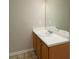 Bathroom vanity featuring a white countertop and wooden cabinets and an oversized mirror at 6010 Capitol Knl, Fairburn, GA 30213