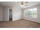 Bedroom with neutral walls, ceiling fan and a bright window, creating a calm atmosphere at 6010 Capitol Knl, Fairburn, GA 30213