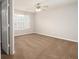 Spacious bedroom features neutral walls, carpet, and a ceiling fan, offering a serene retreat at 6010 Capitol Knl, Fairburn, GA 30213