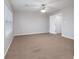 Spacious bedroom features neutral paint, carpet, ceiling fan and a large window with white blinds at 6010 Capitol Knl, Fairburn, GA 30213