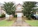 Charming two-story townhouse with brick facade, attached garage, and well-maintained landscaping at 6010 Capitol Knl, Fairburn, GA 30213