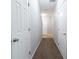 Hallway with multiple interior doors and neutral walls, connecting different areas of the home at 6010 Capitol Knl, Fairburn, GA 30213