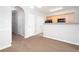 Open kitchen to living room with granite counter top, light wood cabinets and modern appliances at 6010 Capitol Knl, Fairburn, GA 30213