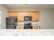 Functional kitchen offers granite counters, wood cabinets, and modern black appliances at 6010 Capitol Knl, Fairburn, GA 30213
