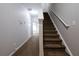 Hallway view with carpeted stairs and a classic white railing leading to the upper level at 6010 Capitol Knl, Fairburn, GA 30213