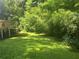 Lush backyard featuring a well-maintained lawn and verdant trees at 95 Heartwood Xing, Dallas, GA 30157