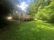 Spacious backyard featuring a wooden deck, perfect for outdoor entertaining, surrounded by lush greenery at 95 Heartwood Xing, Dallas, GA 30157